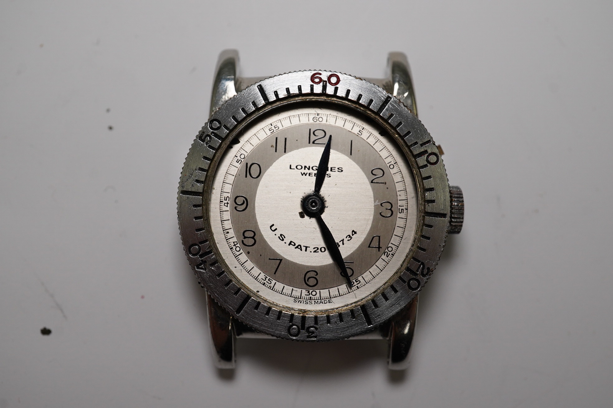 A gentleman's late 1930's steel Longines Weems U.S Patent military pilot's manual wind wrist watch, with Arabic dial, movement c.10L, case diameter 28mm, lacking one crown, no strap. Condition - poor